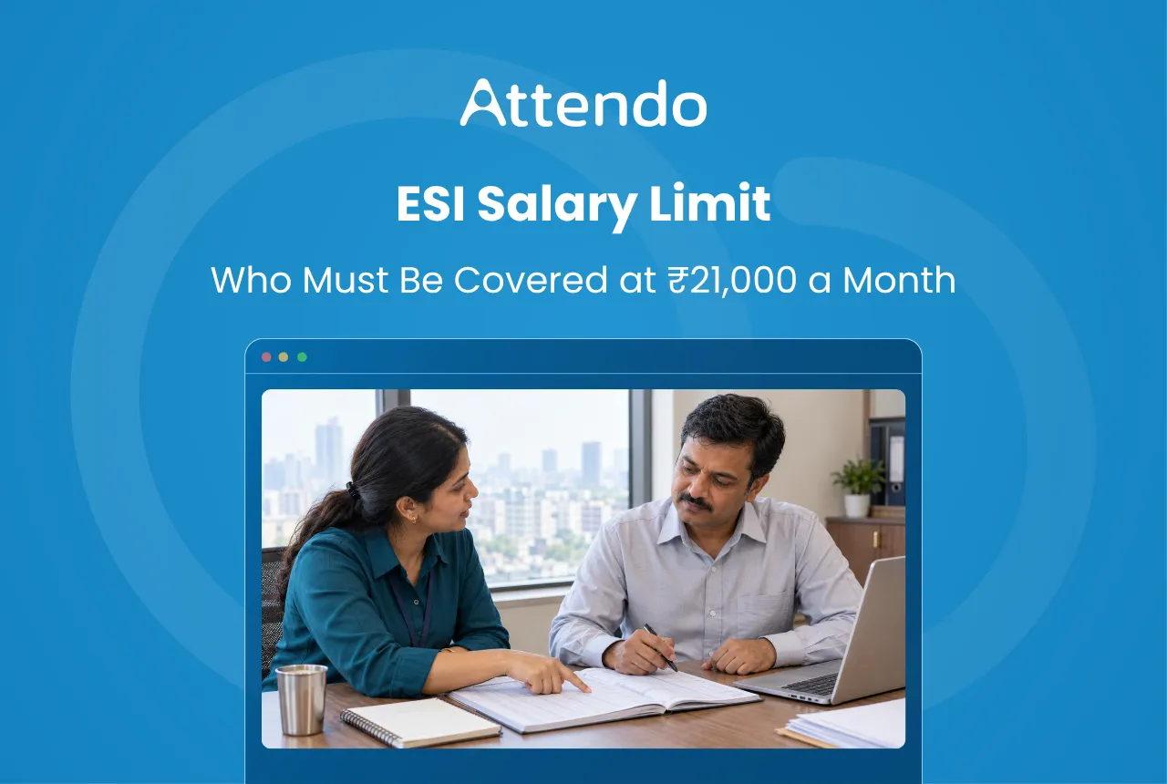 ESI salary limit explained: who must be covered at ₹21,000 a month. Two colleagues in an Indian office check a payroll register together.